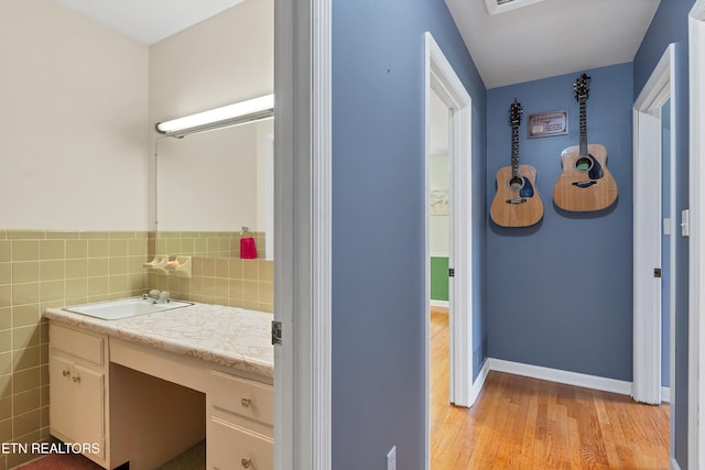 898 W Cunningham St, Alcoa, TN 37701 - bathroom featuring vanity, wood finished floors, and tile walls