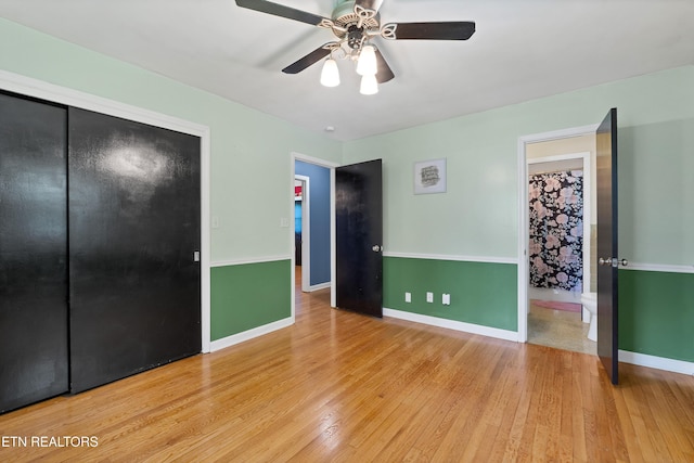 898 W Cunningham St, Alcoa, TN 37701 - unfurnished bedroom with wood finished floors, a closet, ensuite bathroom, and ceiling fan