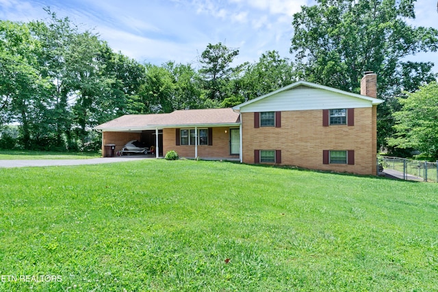 898 W Cunningham St, Alcoa, TN 37701 - split level home with driveway, a chimney, brick siding, an attached carport, and view of scattered trees