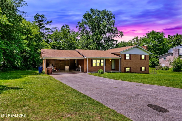 898 W Cunningham St, Alcoa, TN 37701 - split level home with driveway, an attached carport, a yard, and brick siding