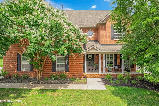 920 Andover View Ln, Knoxville, TN 37922 - view of front facade featuring a front yard, brick siding, covered porch, and roof with shingles