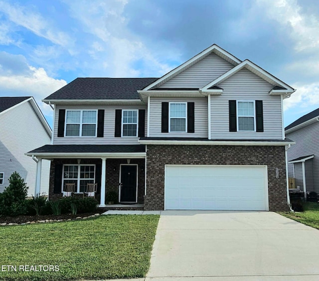 3038 Lazy River Dr, Knoxville, TN 37931 - traditional home with concrete driveway, a front lawn, an attached garage, and brick siding