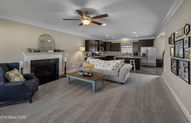 3038 Lazy River Dr, Knoxville, TN 37931 - living room featuring a glass covered fireplace, a ceiling fan, crown molding, and recessed lighting