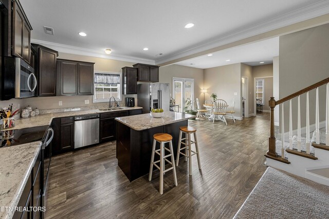 3038 Lazy River Dr, Knoxville, TN 37931 - kitchen featuring stainless steel appliances, a center island, a breakfast bar, dark brown cabinets, and dark wood-style flooring