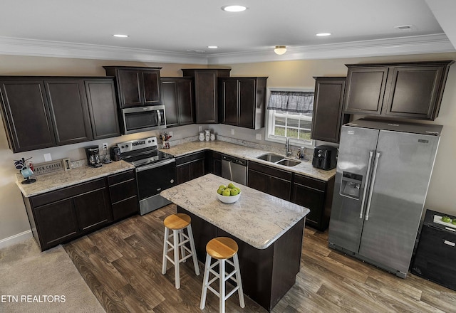 3038 Lazy River Dr, Knoxville, TN 37931 - kitchen with stainless steel appliances, a breakfast bar area, a center island, dark wood-type flooring, and light stone counters