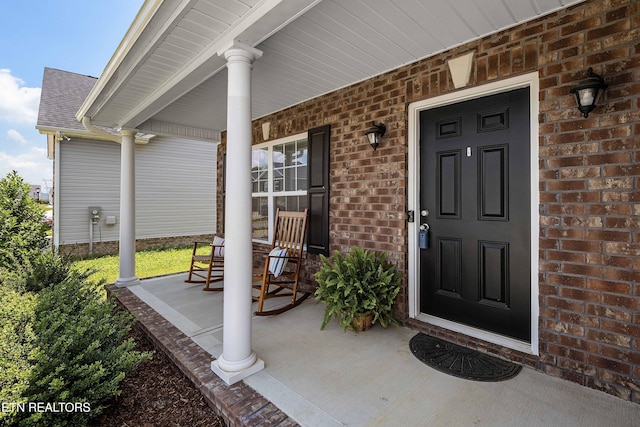 3038 Lazy River Dr, Knoxville, TN 37931 - doorway to property featuring covered porch and brick siding