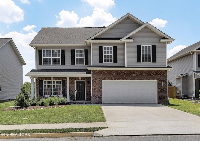 3038 Lazy River Dr, Knoxville, TN 37931 - view of front of home with driveway, a front lawn, and brick siding