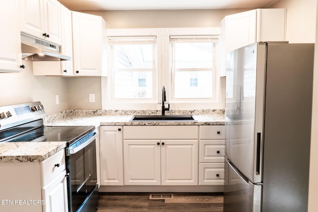 711 E Mountcastle St, Jefferson City, TN 37760 - kitchen with appliances with stainless steel finishes, under cabinet range hood, white cabinetry, and dark wood-style floors