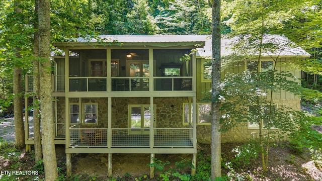 2991 Walden Flats Way, Sevierville, TN 37862 - back of property featuring a sunroom, stone siding, board and batten siding, and a metal roof