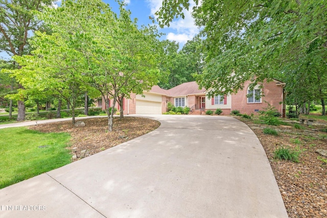 103 Wickham Ln, Fairfield Glade, TN 38558 - view of front of house featuring brick siding, concrete driveway, and a garage