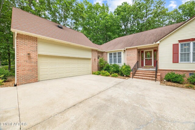 103 Wickham Ln, Fairfield Glade, TN 38558 - view of front of property with brick siding, concrete driveway, a garage, and a shingled roof