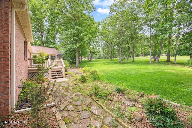 103 Wickham Ln, Fairfield Glade, TN 38558 - view of grassy yard with a wooden deck and view of scattered trees