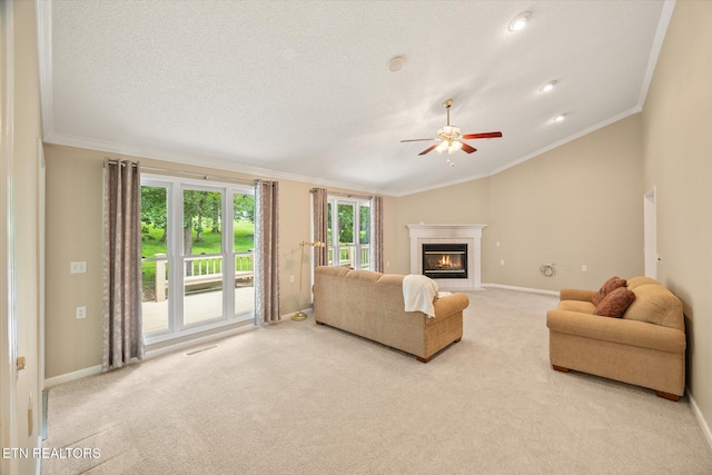 103 Wickham Ln, Fairfield Glade, TN 38558 - carpeted living area with ornamental molding, a tile fireplace, a ceiling fan, and lofted ceiling