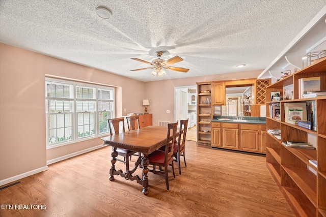 103 Wickham Ln, Fairfield Glade, TN 38558 - dining space with light wood-style floors, a ceiling fan, and a textured ceiling
