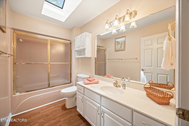 103 Wickham Ln, Fairfield Glade, TN 38558 - bathroom with a skylight, vanity, combined bath / shower with glass door, and wood finished floors