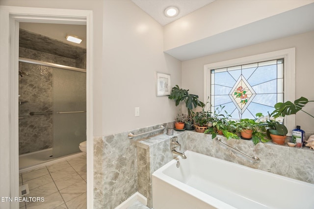 103 Wickham Ln, Fairfield Glade, TN 38558 - full bathroom featuring marble finish floors, a stall shower, and a garden tub