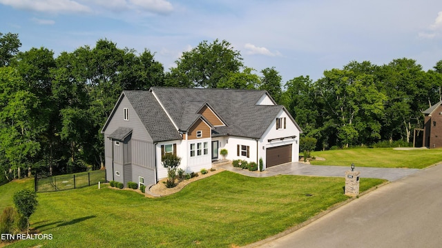 9401 Shirley Ann Rd, Kodak, TN 37764 - modern farmhouse style home with asphalt driveway, an attached garage, view of wooded area, and board and batten siding