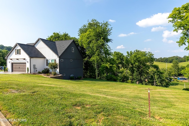 9401 Shirley Ann Rd, Kodak, TN 37764 - view of side of home featuring a lawn, board and batten siding, a garage, and driveway