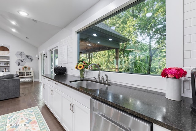 9401 Shirley Ann Rd, Kodak, TN 37764 - kitchen featuring stainless steel dishwasher, lofted ceiling, white cabinetry, dark stone countertops, and dark wood-style flooring