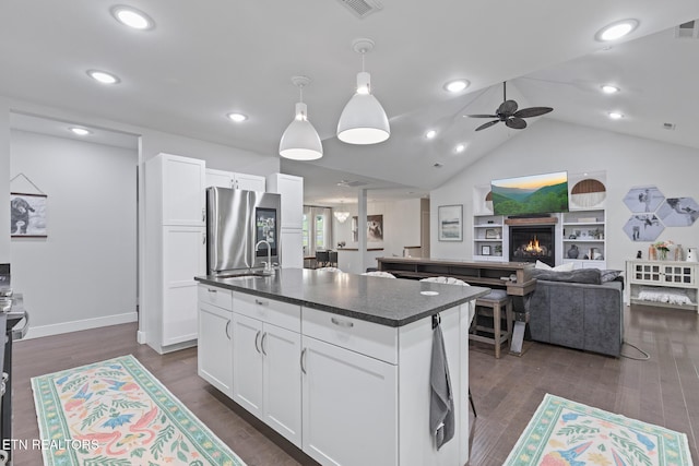 9401 Shirley Ann Rd, Kodak, TN 37764 - kitchen with smart refrigerator, a kitchen island with sink, ceiling fan, a warm lit fireplace, and white cabinets