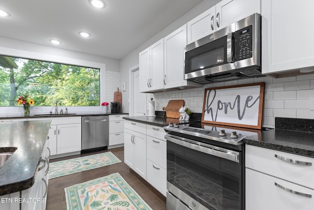 9401 Shirley Ann Rd, Kodak, TN 37764 - kitchen featuring appliances with stainless steel finishes, recessed lighting, backsplash, white cabinetry, and dark wood-style floors