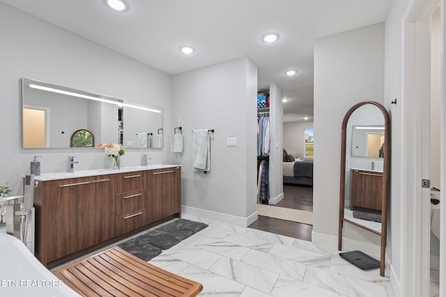 9401 Shirley Ann Rd, Kodak, TN 37764 - ensuite bathroom featuring double vanity, recessed lighting, and marble finish flooring