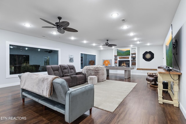 9401 Shirley Ann Rd, Kodak, TN 37764 - living room with ceiling fan, recessed lighting, dark wood-style flooring, and a warm lit fireplace