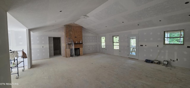 2333 Arrow Trl, Monterey, TN 38574 - unfurnished living room with a fireplace and lofted ceiling