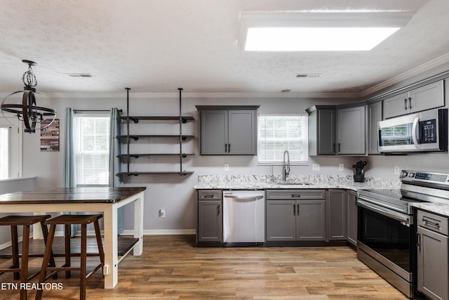 8306 Foxworth Trl, Powell, TN 37849 - kitchen with stainless steel appliances, gray cabinets, a chandelier, healthy amount of natural light, and a textured ceiling