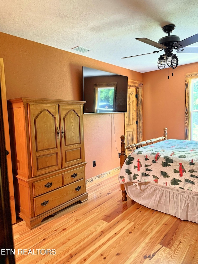 1659 Cherohala Skwy, Tellico Plains, TN 37385 - bedroom featuring light wood-style flooring, a textured ceiling, and ceiling fan