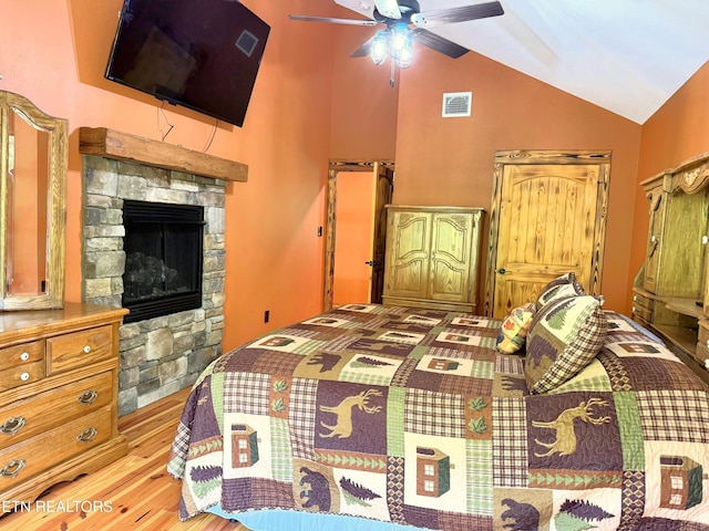 1659 Cherohala Skwy, Tellico Plains, TN 37385 - bedroom with lofted ceiling, wood finished floors, a stone fireplace, and ceiling fan