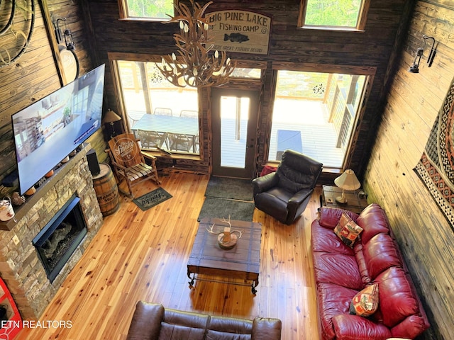 1659 Cherohala Skwy, Tellico Plains, TN 37385 - living room featuring hardwood / wood-style floors, a chandelier, healthy amount of natural light, and a fireplace