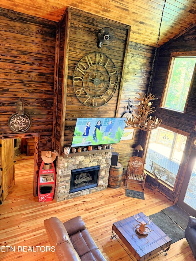 1659 Cherohala Skwy, Tellico Plains, TN 37385 - living area featuring hardwood / wood-style flooring, wooden ceiling, a stone fireplace, and vaulted ceiling