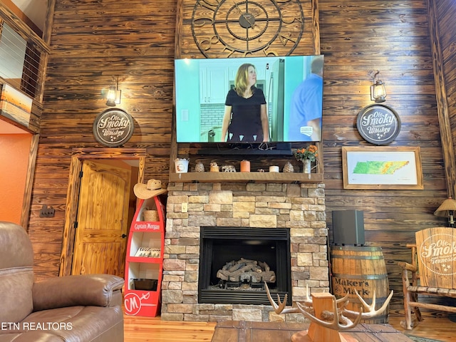 1659 Cherohala Skwy, Tellico Plains, TN 37385 - living room with wooden walls, wood finished floors, and a stone fireplace