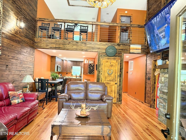 1659 Cherohala Skwy, Tellico Plains, TN 37385 - living room with a high ceiling, wood walls, and light wood finished floors
