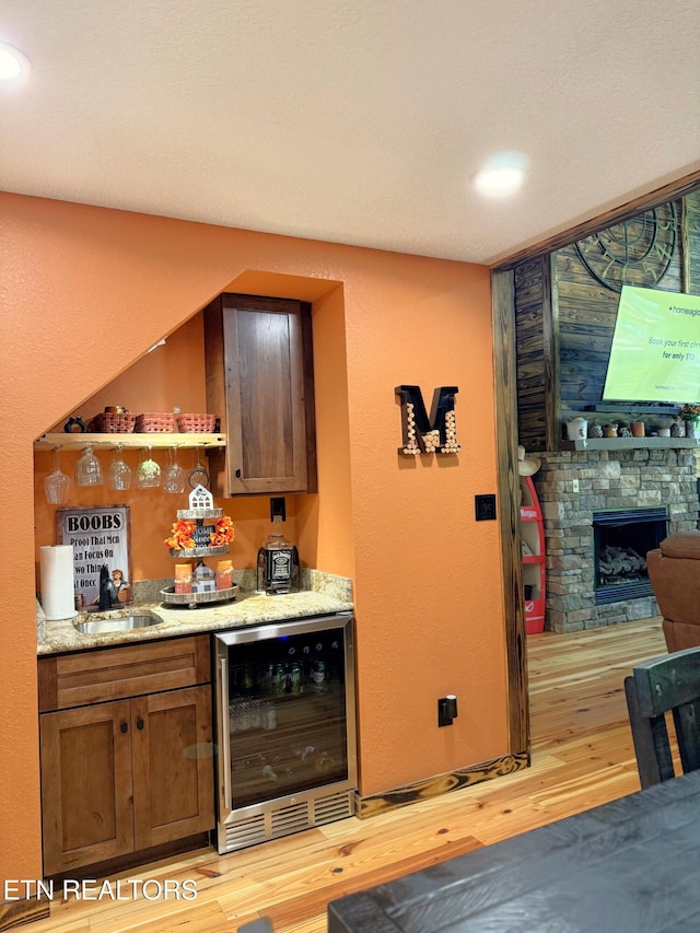 1659 Cherohala Skwy, Tellico Plains, TN 37385 - indoor dry bar featuring wine cooler, light wood finished floors, a fireplace, and recessed lighting