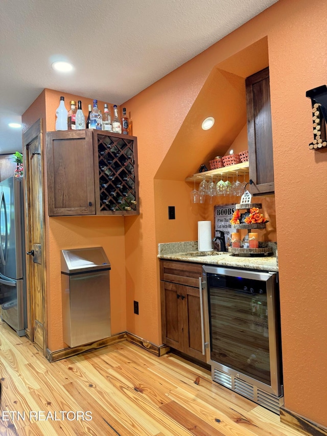 1659 Cherohala Skwy, Tellico Plains, TN 37385 - indoor dry bar with wine cooler, freestanding refrigerator, light wood-type flooring, recessed lighting, and a textured ceiling