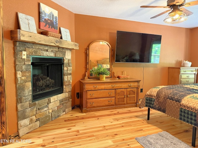 1659 Cherohala Skwy, Tellico Plains, TN 37385 - bedroom featuring light wood-style flooring, a fireplace, and a ceiling fan