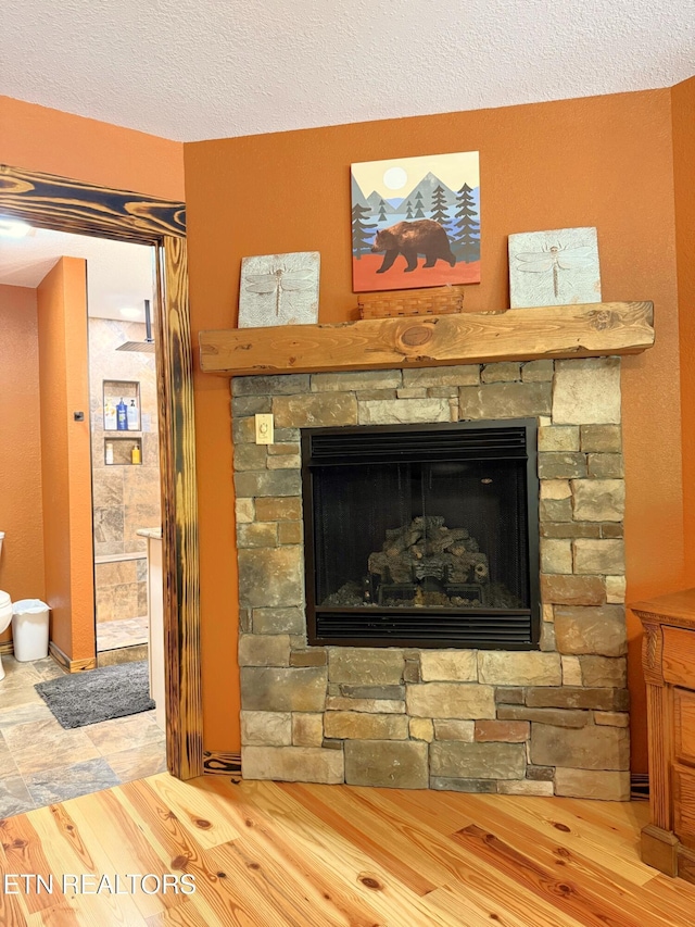 1659 Cherohala Skwy, Tellico Plains, TN 37385 - detailed view of a fireplace, wood finished floors, and a textured ceiling