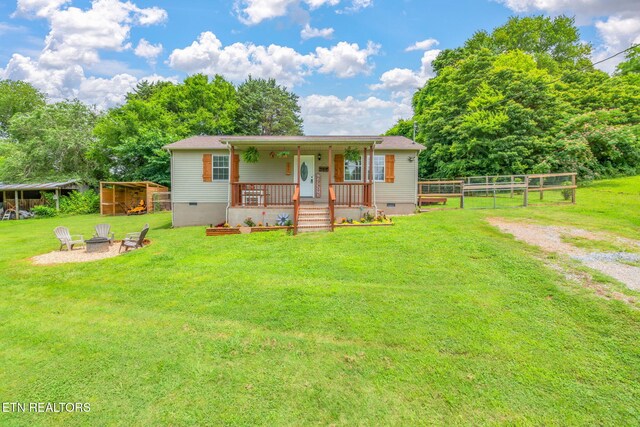 555 N Trigonia Rd, Greenback, TN 37742 - ranch-style house featuring crawl space, covered porch, an outdoor fire pit, and an outbuilding