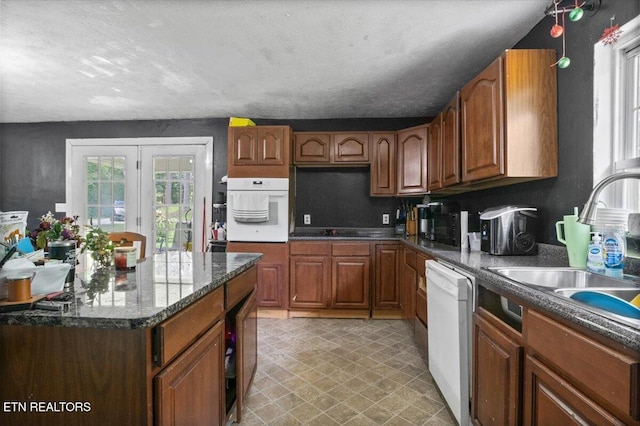 330 Dilbeck Ln, Caryville, TN 37714 - kitchen with white appliances, plenty of natural light, brown cabinets, and light floors