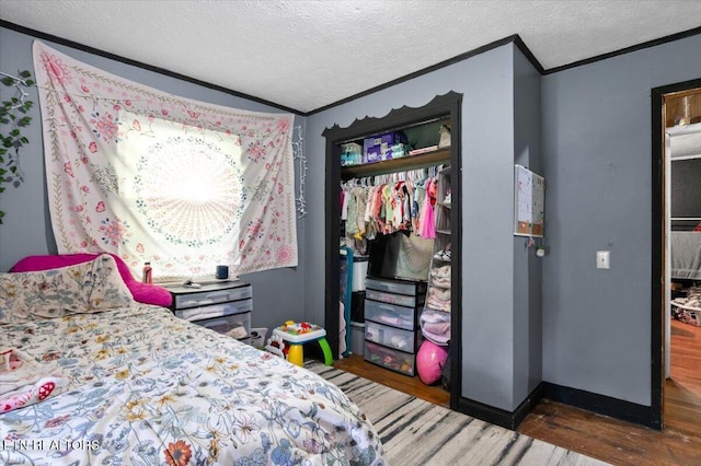 330 Dilbeck Ln, Caryville, TN 37714 - bedroom with crown molding, wood finished floors, a closet, and a textured ceiling