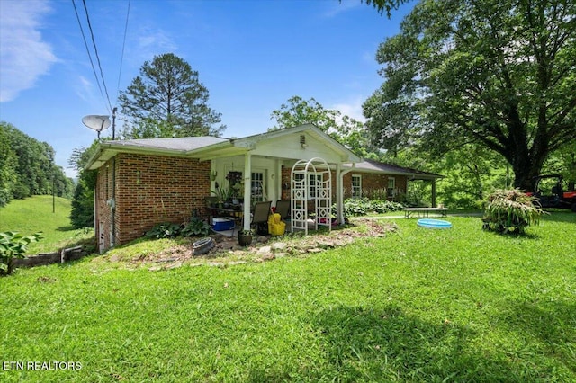 330 Dilbeck Ln, Caryville, TN 37714 - back of property with a yard and brick siding