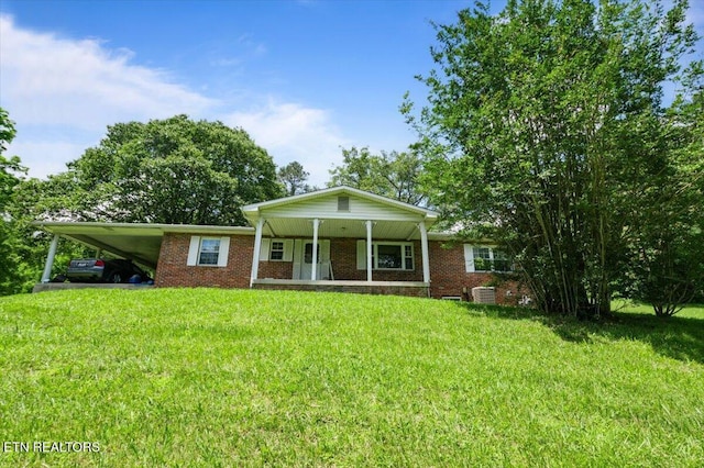 330 Dilbeck Ln, Caryville, TN 37714 - ranch-style house featuring an attached carport, a front yard, brick siding, and a porch