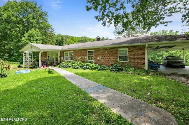 330 Dilbeck Ln, Caryville, TN 37714 - single story home featuring a front lawn, brick siding, a chimney, and a carport