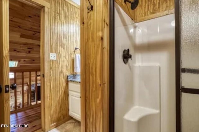 315 Greenwood Way, Pigeon Forge, TN 37863 - full bathroom featuring a shower stall, wooden walls, and vanity