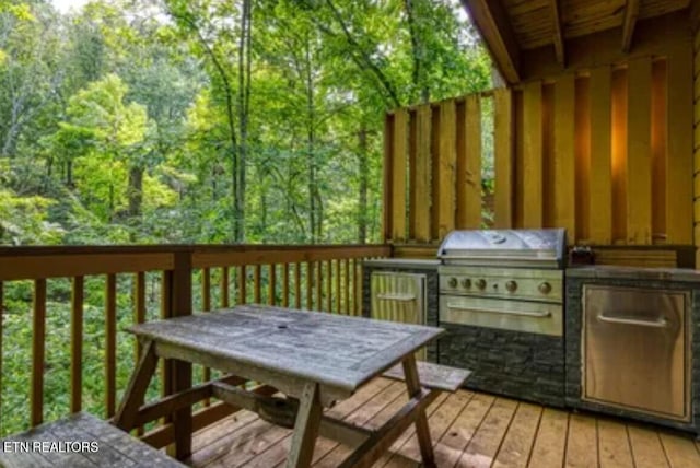 315 Greenwood Way, Pigeon Forge, TN 37863 - wooden terrace featuring exterior kitchen and outdoor dining space