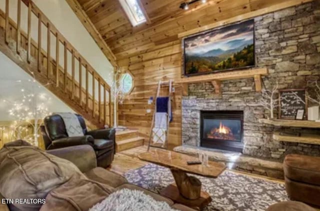 315 Greenwood Way, Pigeon Forge, TN 37863 - living area featuring stairs, wood finished floors, a fireplace, a skylight, and wood ceiling