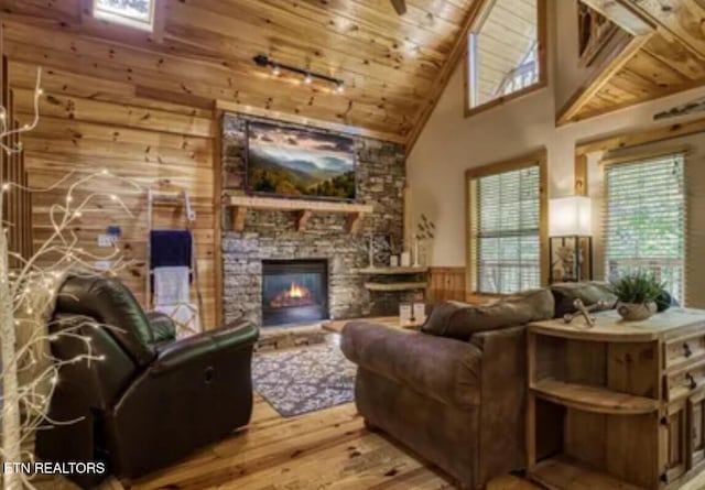 315 Greenwood Way, Pigeon Forge, TN 37863 - living area with wooden ceiling, hardwood / wood-style floors, high vaulted ceiling, wood walls, and wainscoting