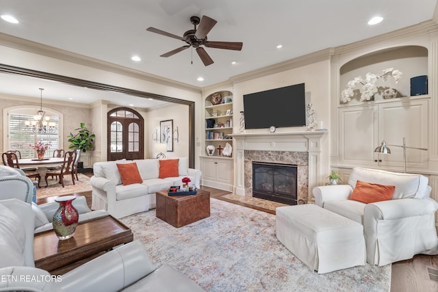 12209 Preston Landing Way, Knoxville, TN 37922 - living room with a ceiling fan, ornamental molding, a chandelier, a fireplace, and built in features